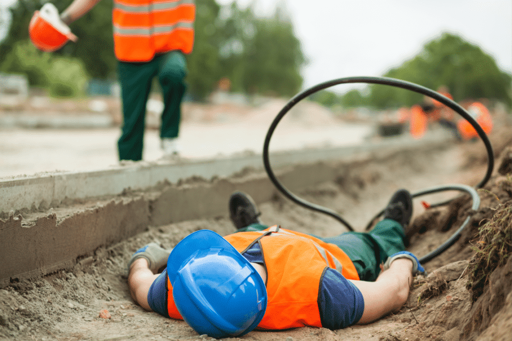 Industrial worker injured and lying on the ground