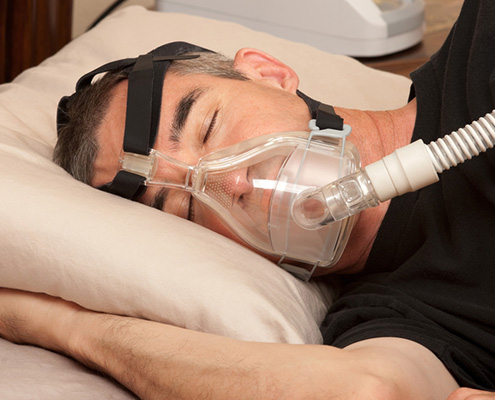 FS Blog man with sleep apnea and CPAP machine