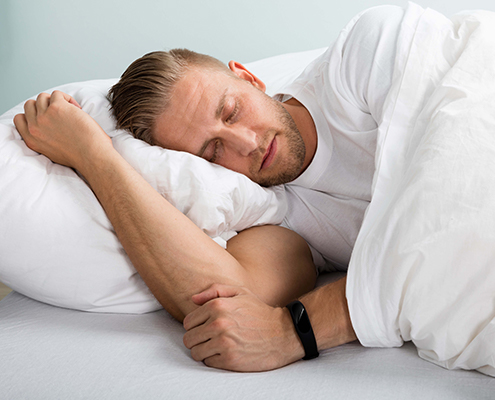 Young Man Sleeping On Bed With Eyes Closed | Fatigue Science